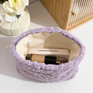 Detailed interior view of purple plush cosmetic bag filled with beauty products