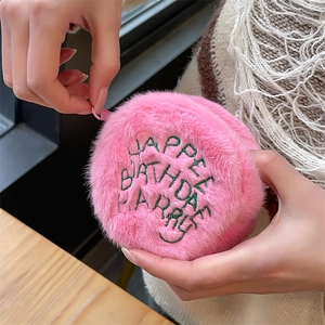 Close-up of pink plush coin purse with Happee Birthdae Harry embroidery detail