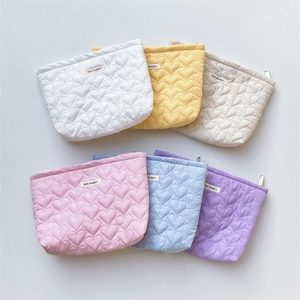 Quilted heart cosmetic bags in six pastel colors with a soft puffy texture and zipper