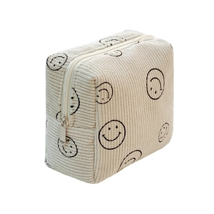Large capacity cream corduroy cosmetic bag with black smile patterns and zipper closure