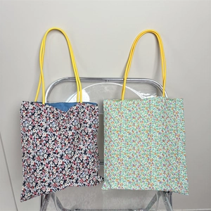 Floral canvas tote bags with rope handles in navy and green patterns for women