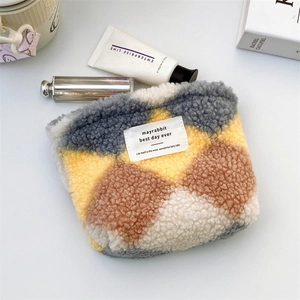 Detailed plush cosmetic bag with yellow and grey plaid pattern and zip closure