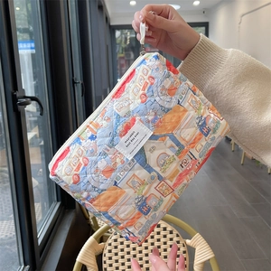 Quilted cotton makeup bag detail with colorful cartoon rabbit and street illustration