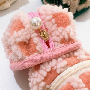 Close-up of pink waffle texture fabric with pearl zipper detail on storage pouch