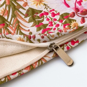 Detailed macro shot of floral jacquard fabric with a sleek metal invisible zipper closure