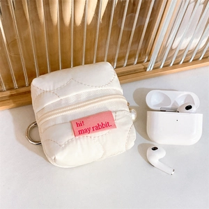 Quilted beige earphone case with pink woven label and metallic hook for storage