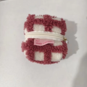 Macro detail of red and white checkered plush waffle fleece earphone pouch with zipper