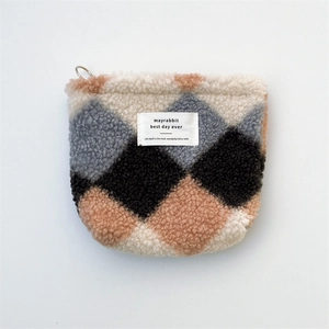 Close-up of plush lambskin fleece small cosmetic bag with vintage diamond pattern
