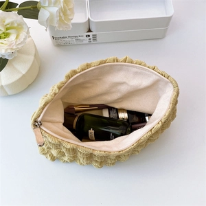 Close-up of cloud makeup bag showing spacious interior with white canvas lining