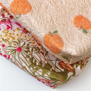 Detailed view of jacquard makeup bags with pumpkin patterns and floral embroidery