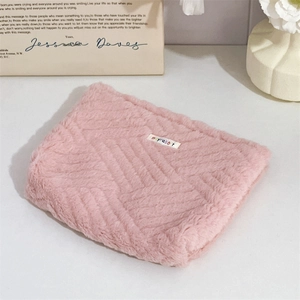 Close-up of pink plush storage bag with moyrabbit label and soft faux fur texture