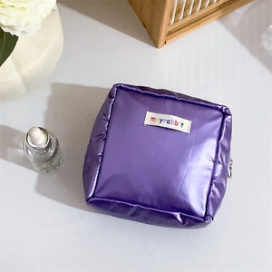 Detail of purple satin nylon pouch with zipper and central mayrabbit brand label
