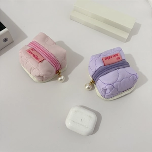 Quilted mini pouches in pink and purple with pearl zippers and small fabric labels