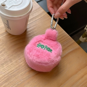 Detailed view of pink plush pouch with green Harry Potter embroidery and metal hook