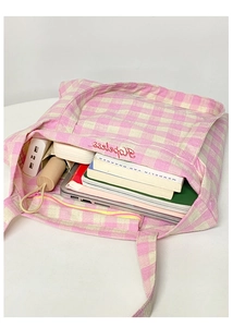Spacious pink gingham canvas tote bag interior holding a laptop, books, and essentials