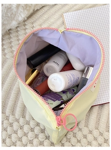 Detailed top view of a heart-shaped makeup bag with colorful inner storage space