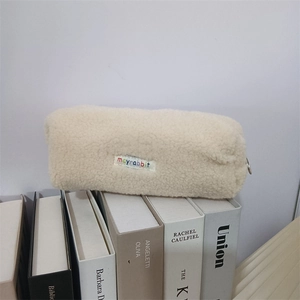 Macro detail of plush sherpa pencil case featuring a colorful mayrabbit letter patch