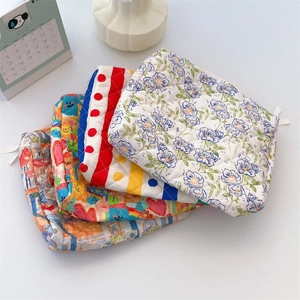 Close-up of quilted cotton makeup bags in floral, cartoon, and striped patterns