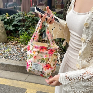 Floral canvas bucket bag with drawstring and top handles in a fresh pastoral style