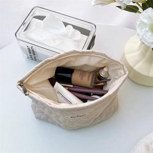 Internal view of cream quilted heart makeup bag showing spacious storage for cosmetics