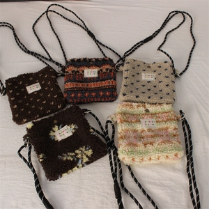Flat lay of small plush crossbody bags in five assorted patterns and woven straps