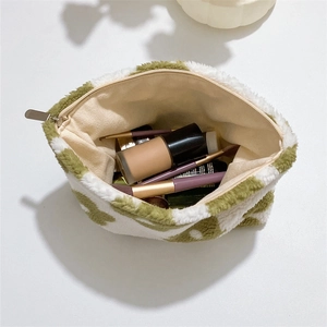 Top view of plush floral cosmetic bag showing spacious interior with makeup brushes