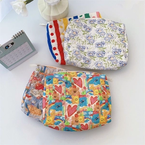 Quilted cotton cosmetic bags in assorted patterns including floral and stripes