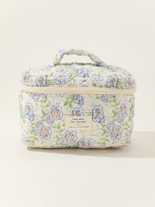 Quilted floral makeup bag with top handle and vintage blue flowers on ivory cotton fabric