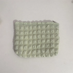 Detailed close-up of mint green popcorn texture fabric on a large makeup wash bag