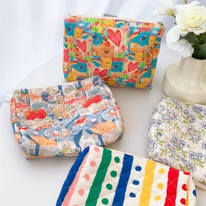 Close-up of quilted cotton cosmetic bags with floral, rainbow and polka dot patterns