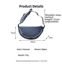 Detail view of navy blue crescent bag with white trim and size specs in 29x15x9cm