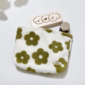 Detail of soft fleece flower makeup bag featuring high-quality plush texture and logo label