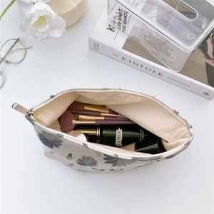 Top view of large floral canvas makeup bag with silver zipper and cosmetic storage
