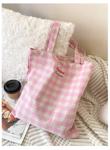 Close-up of pink plaid canvas tote bag featuring Hopeless Romantic floral embroidery