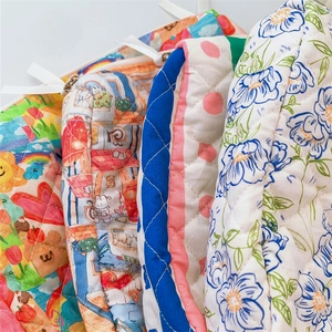 Detail of quilted cotton cosmetic bags with various patterns and soft fabric texture