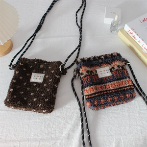 Plush crossbody bag with dots and stripes pattern and woven shoulder strap