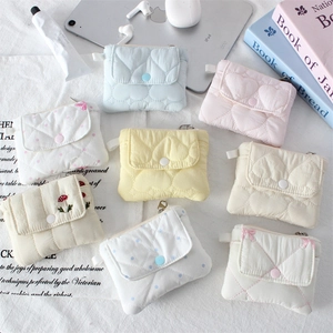 Flat lay of quilted cotton coin purses in various colors and mushroom embroidery patterns