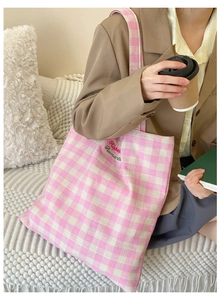 Close-up of pink and white gingham canvas tote bag featuring Hope Romantic embroidery