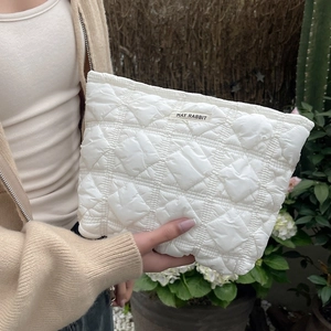 Quilted white cosmetic bag featuring May Rabbit brand label and stylish square stitching
