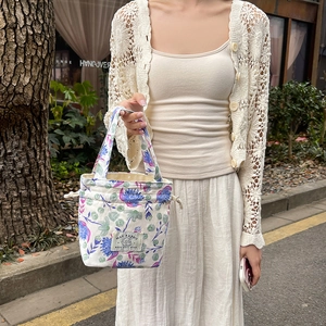 Detailed view of floral canvas drawstring tote bag with cute rabbit illustration