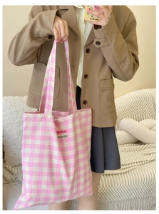 Detail of pink plaid canvas tote with hopeless romantic embroidery for students