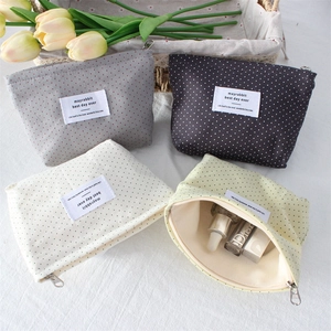 Polka dot canvas makeup bags in four colors with secure silver zippers and fabric labels