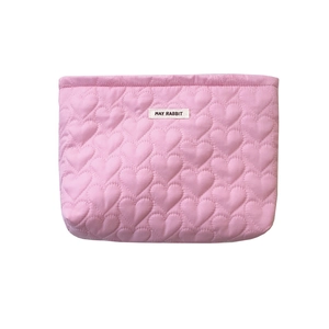 Pink quilted makeup bag with heart stitching and May Rabbit label on white background