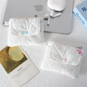 Detail of quilted polka dot mini pouches with snap buttons for coins and earbuds
