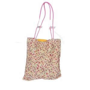 Minimalist floral canvas tote bag with red and yellow flower patterns and pink straps