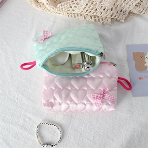 Quilted heart cosmetic bags in mint green and pink with cute bow accents for organization