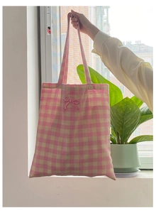 Close-up of pink checkered canvas tote bag with a cute 3D bow decoration