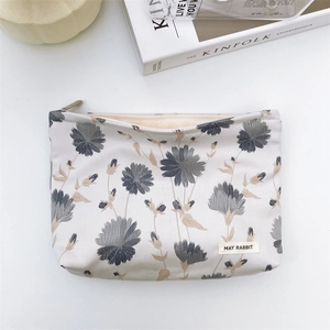 Detailed top view of large capacity floral jacquard cosmetic bag with MAY RABBIT label