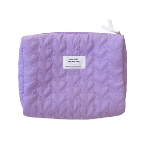 Purple quilted heart pattern storage bag with a white label on a white background