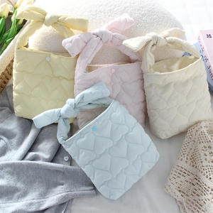 Detailed heart quilted fabric mini tote bags in pastel yellow, pink, white, and blue hues